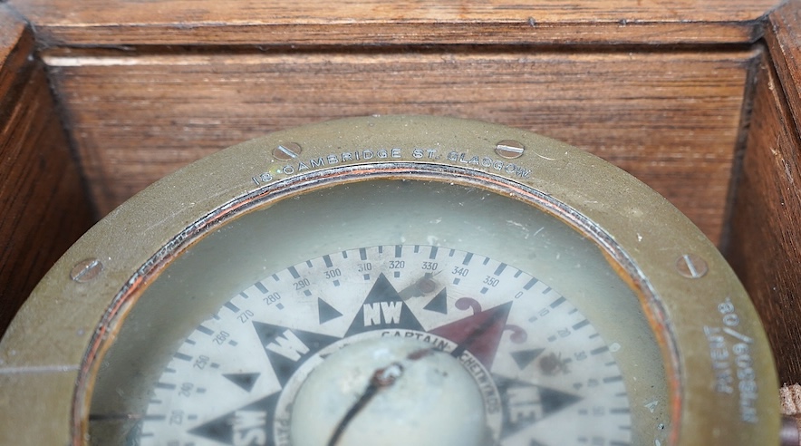 A ‘Kelvin & James White Ltd. 18 Cambridge St. Glasgow’ ship's compass, in a later oak case, 13cm high, 21cm wide, 19cm deep. Condition - poor to fair.